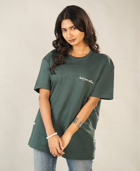Woman wearing a green t-shirt with text on a plain background