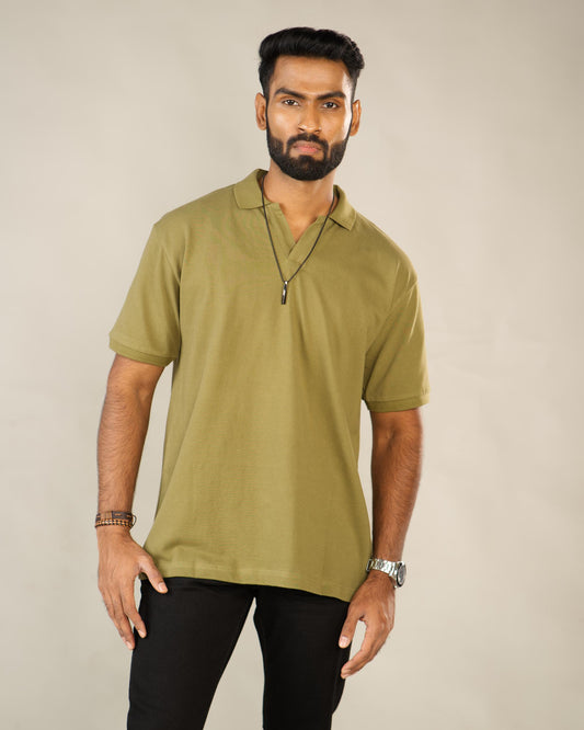 Man wearing a green polo shirt against a plain background