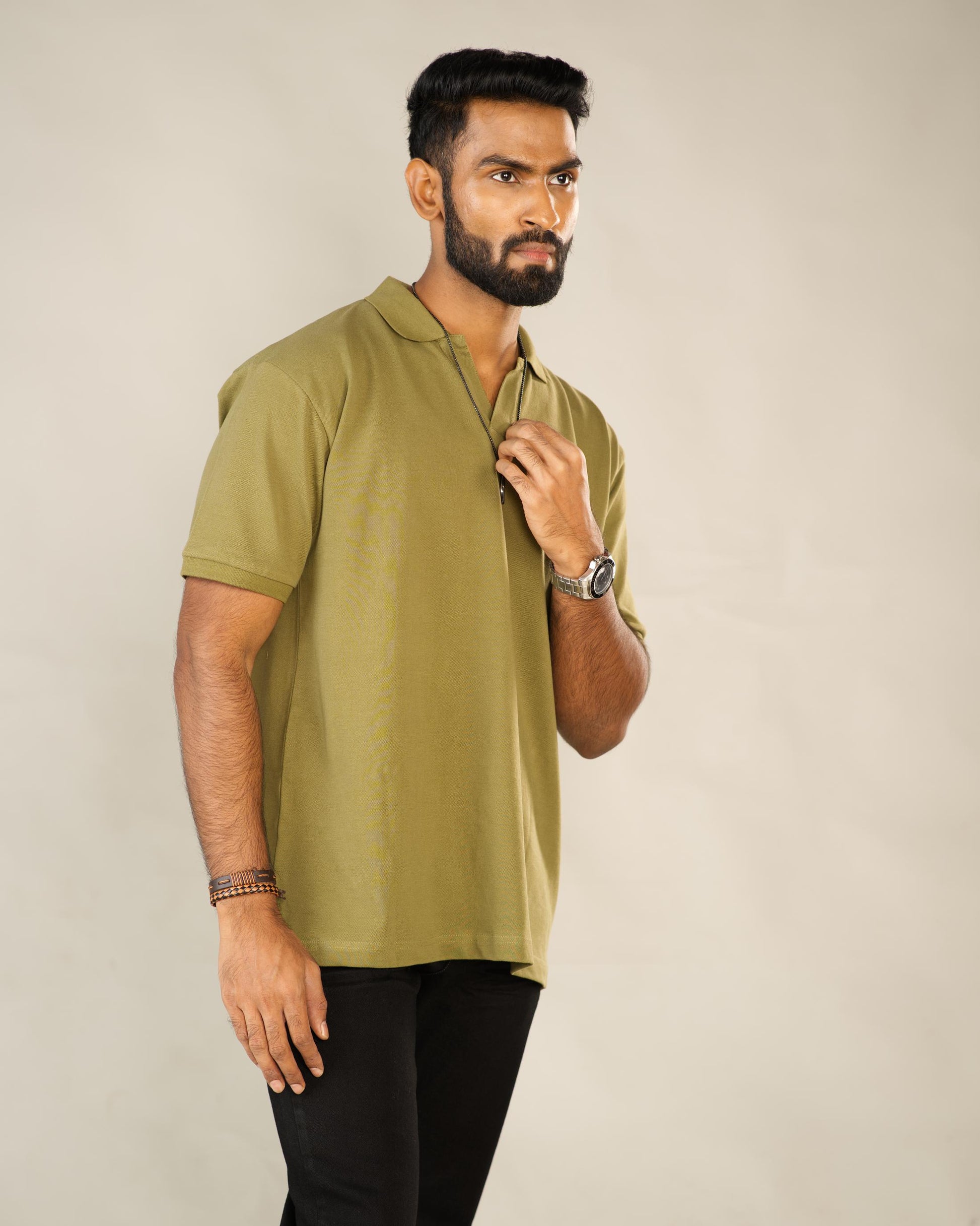 Man wearing a green polo shirt against a plain background - Image 3