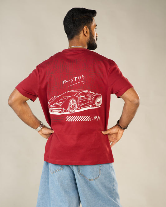 Man wearing a red t-shirt with a car design on the back, standing against a plain background.