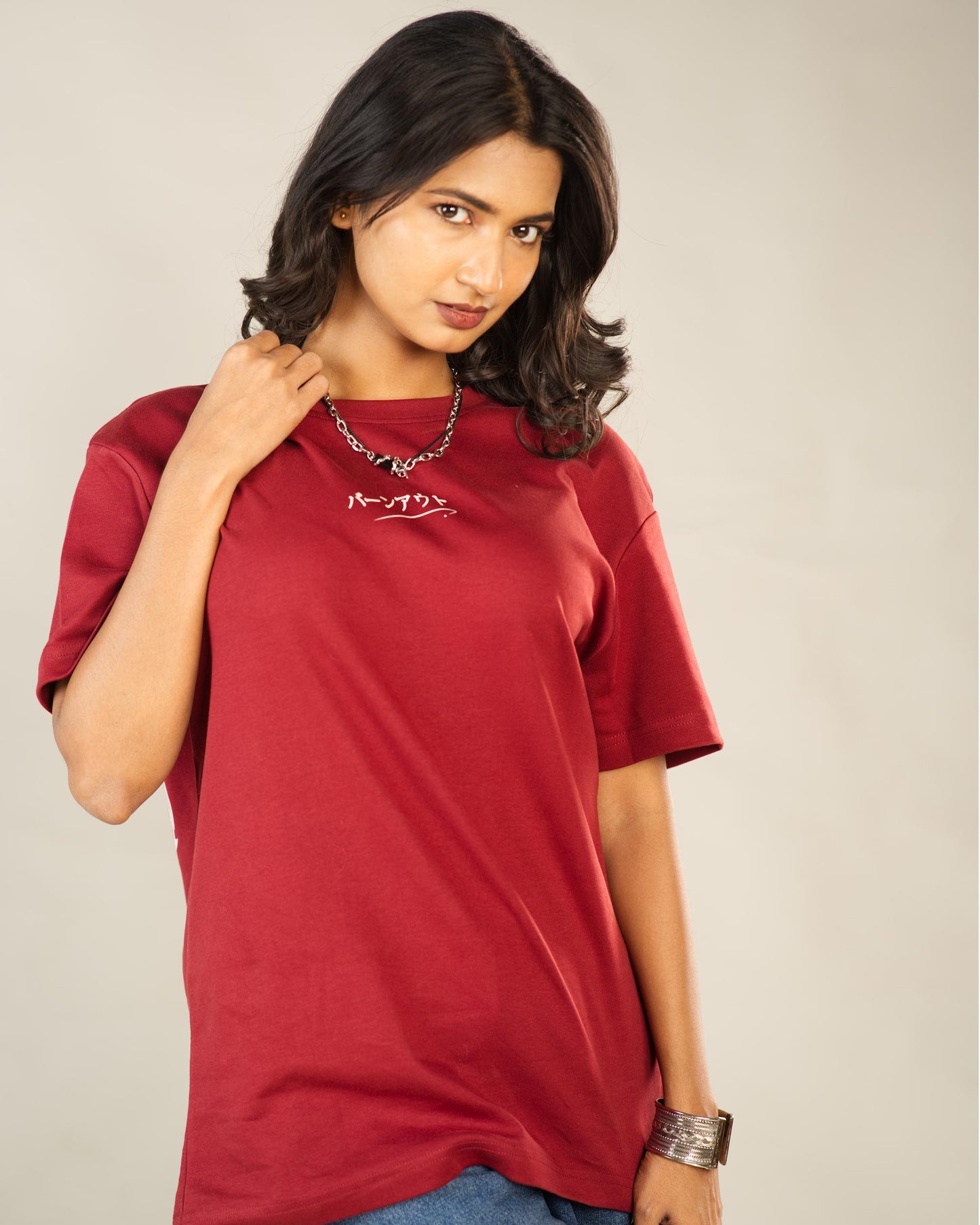 Woman wearing a red t-shirt with text on it against a plain background