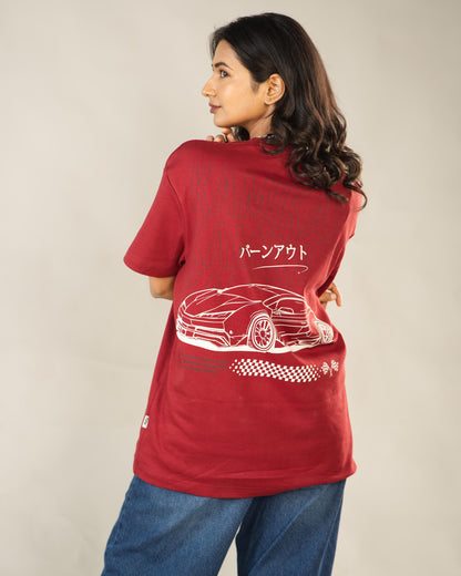 Person wearing a red t-shirt with a car design on the back against a plain background