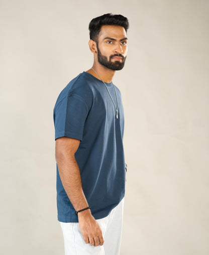 Man wearing a blue t-shirt against a plain background