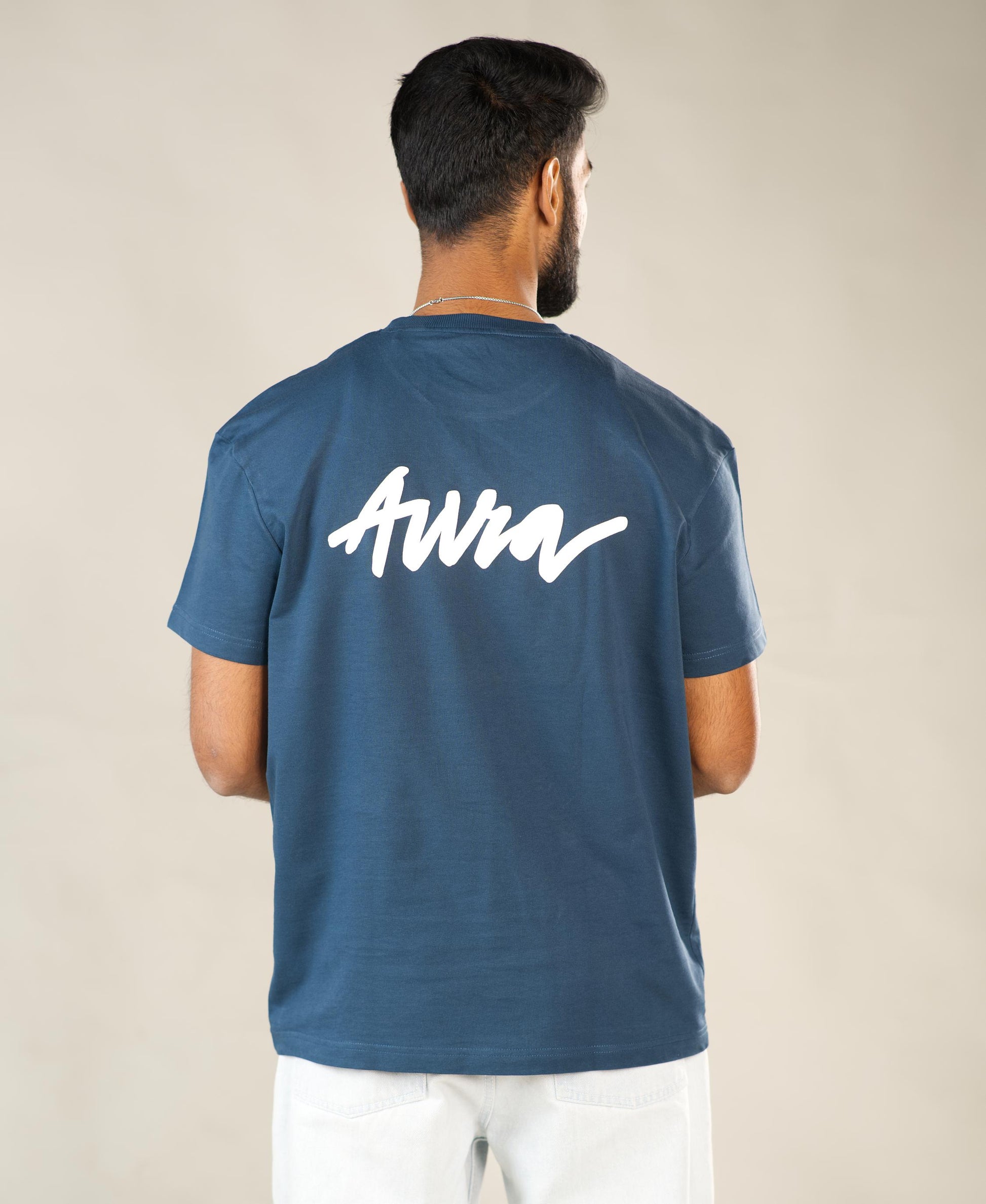 Man wearing a blue t-shirt with 'AWM' logo on the back against a plain background - Image 7