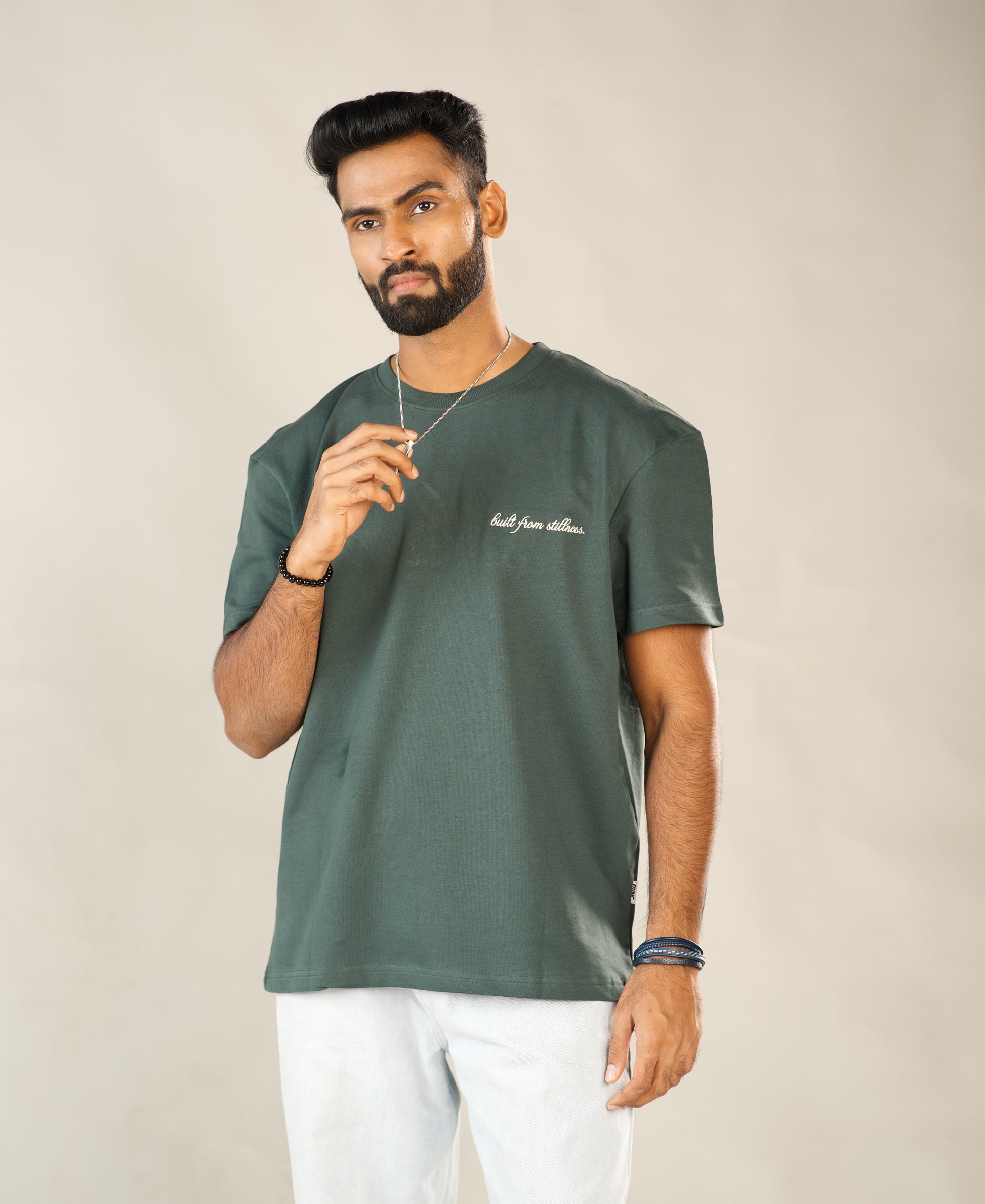 Man wearing a green t-shirt with text on a plain background - Image 4