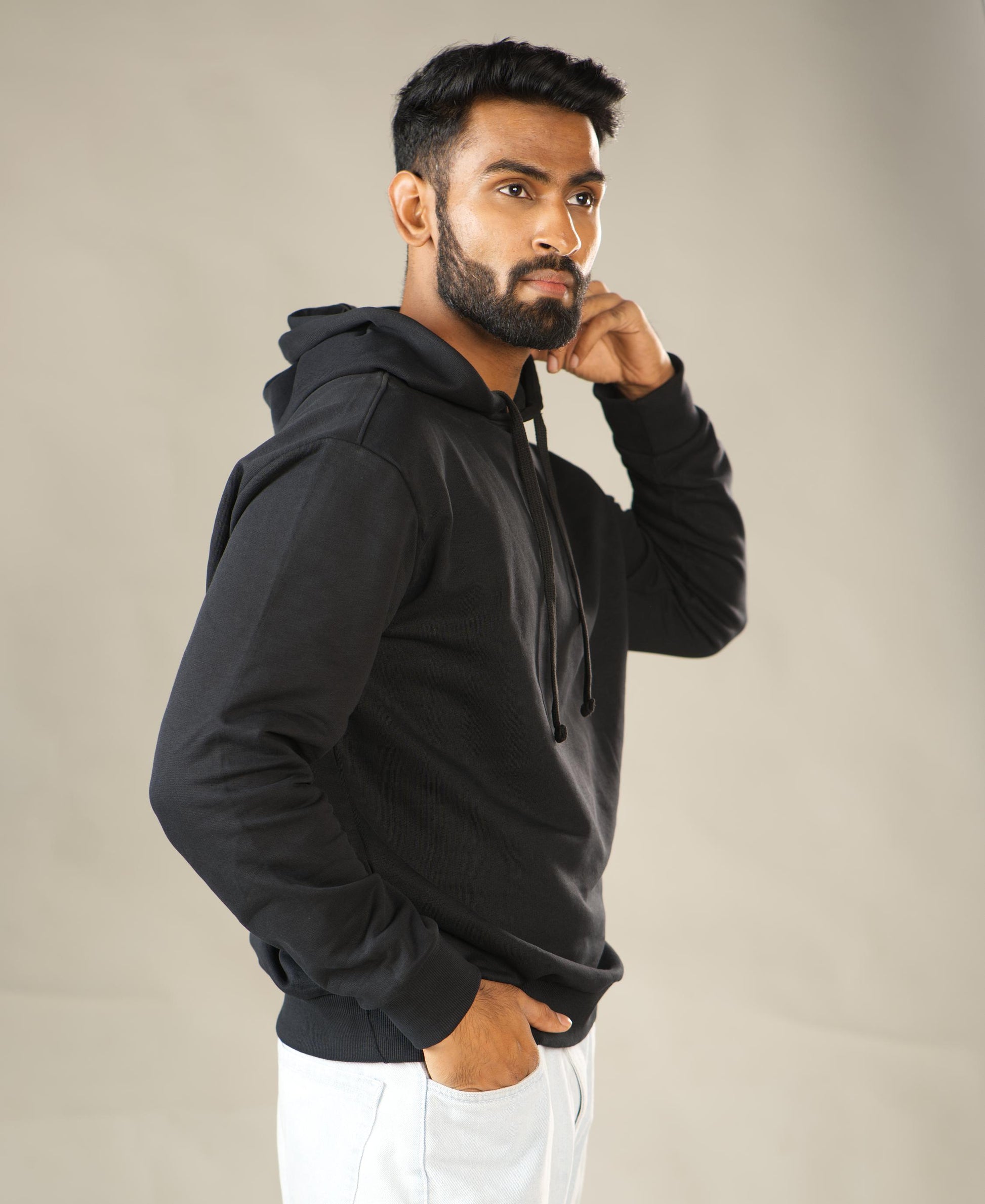 Man wearing a black hoodie against a plain background - Image 5