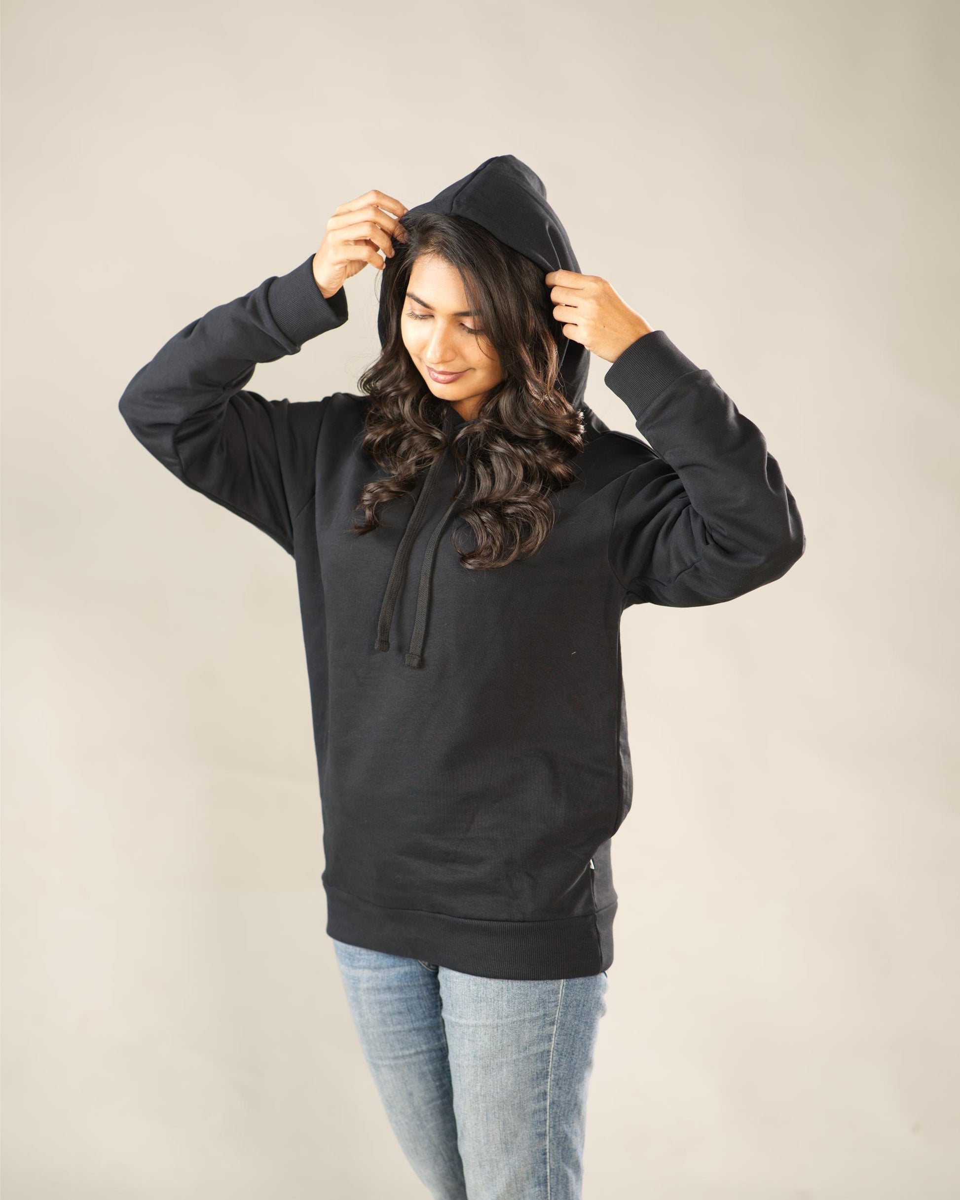 Person wearing a black hoodie against a plain background - Image 4